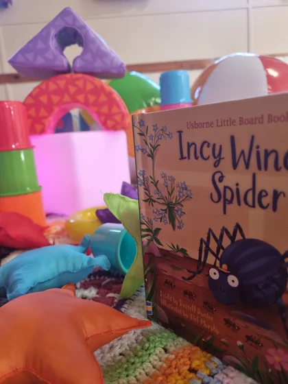 An Incy Wincy Spider storybook with glowing sensory lights and colourful toys