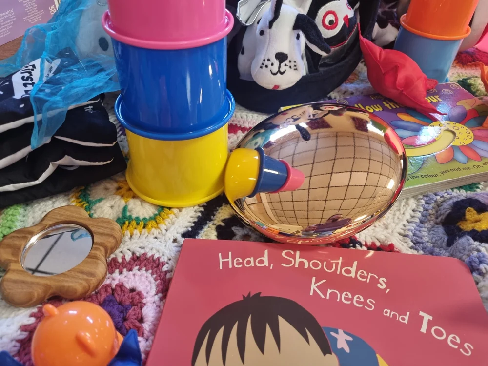 A tambourine, tactile toys and a Head, Shoulders, Knees and Toes book